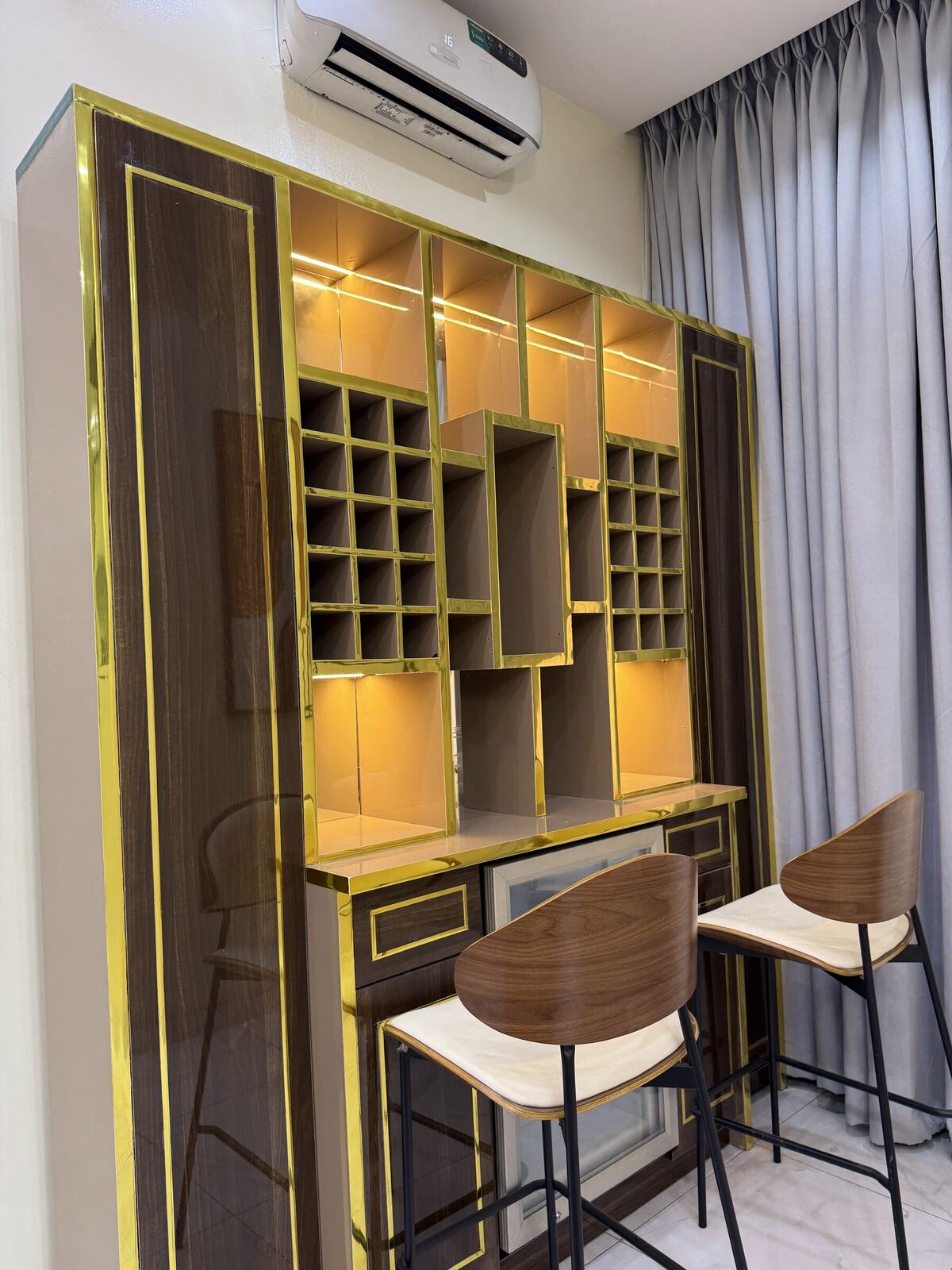 Custom gold-trimmed bar cabinet by Chavvah Interiors